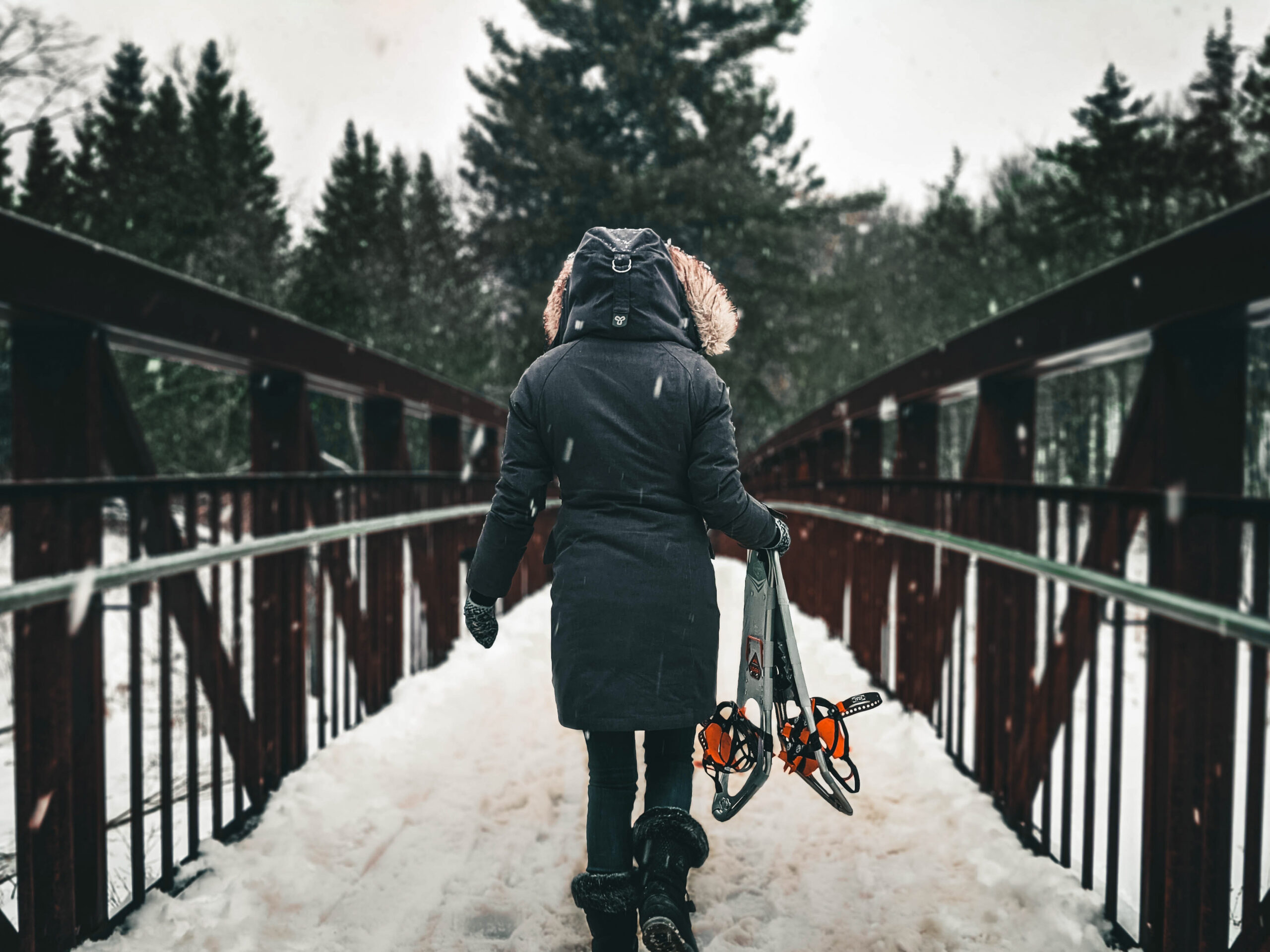 person holding snow shoes in Chamonix winter snow 